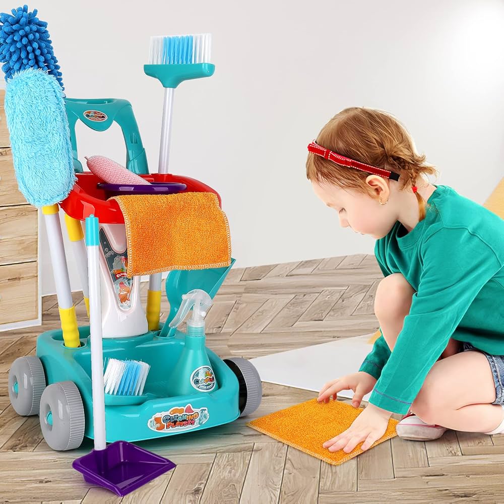 girl is playing with child sized cleaning set