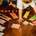 child playing with sensori material. color tablets
