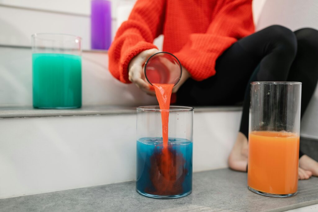 kid is pouring water from one jar to other