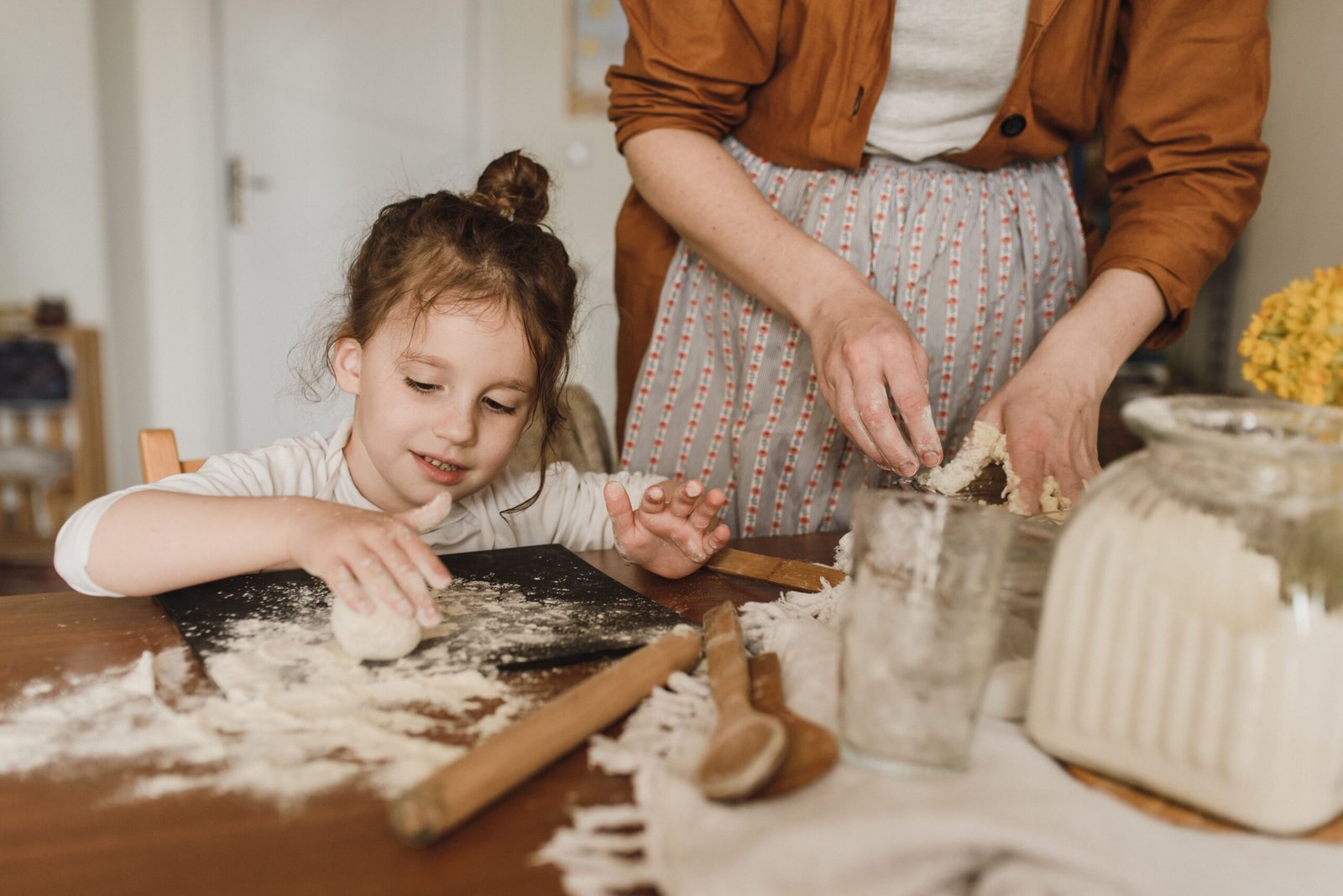 the girl is baking with her mother