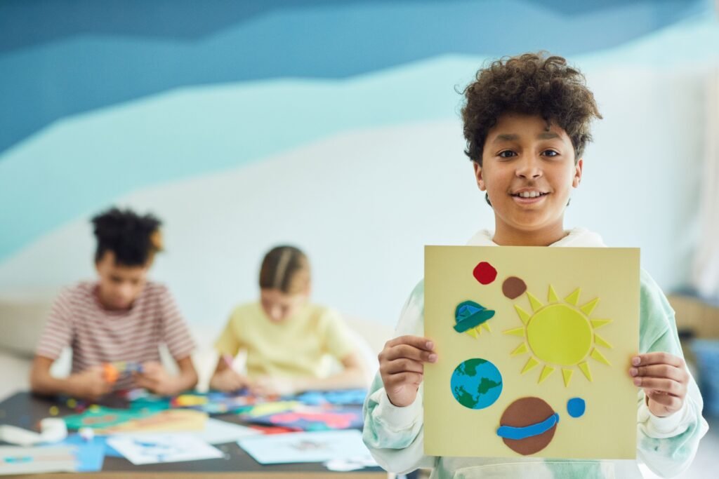 a kid is showing his productive art